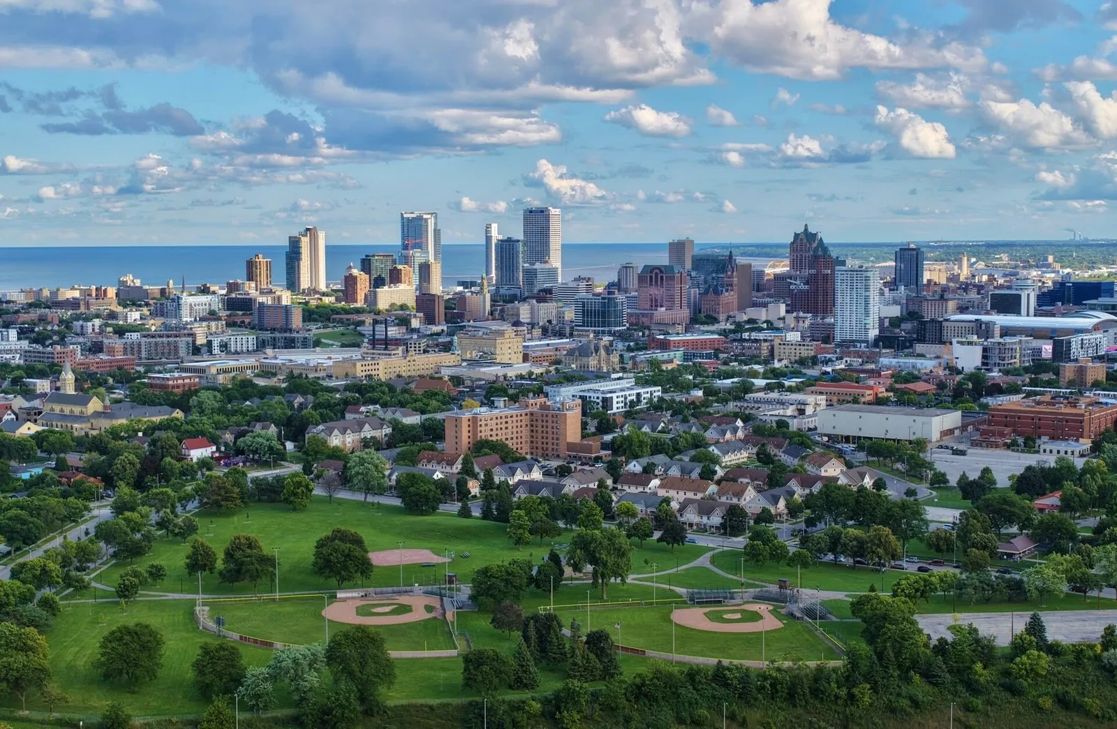Archival Milwaukee skyline above a green park looking toward Lake Michigan