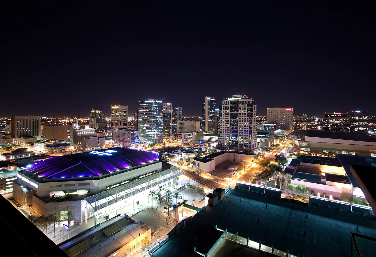 Archival downtown Phoenix skyline with colorful city lights at night