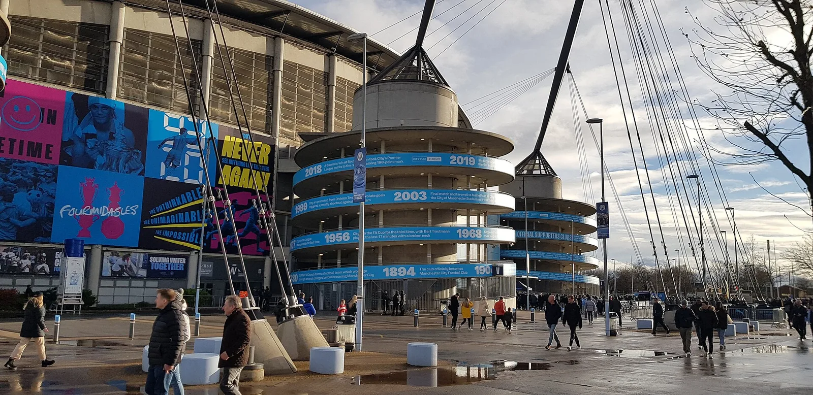 Etihad Stadium west stand exterior with blue club murals, photographed in January 2023