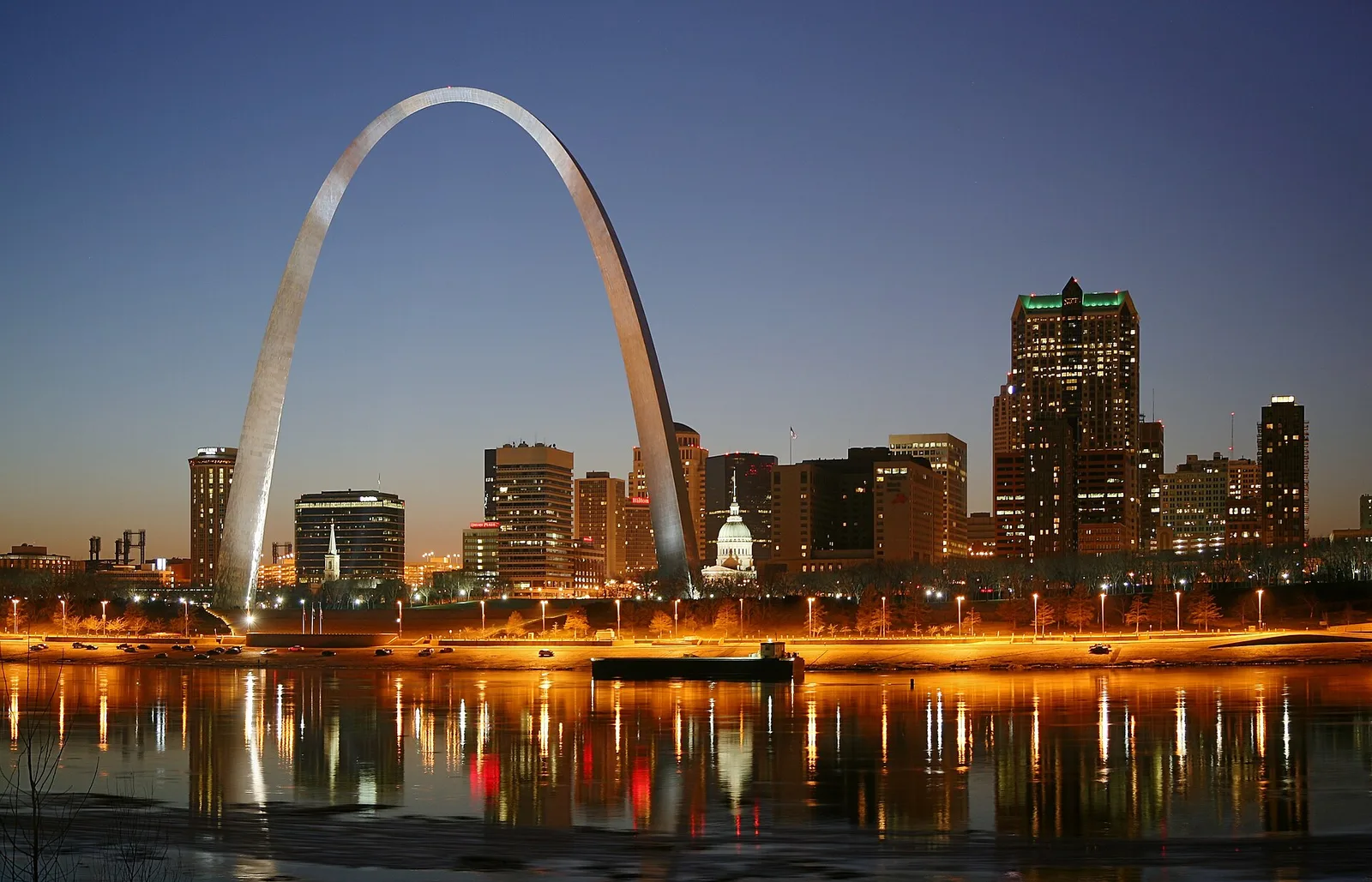 Archival St. Louis skyline and Gateway Arch reflected across the Mississippi River at dusk